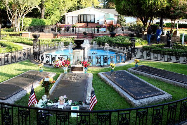 <p>Raymond Boyd/Getty</p> Minnie Mae Presley, Elvis Presley, Vernon Presley and Gladys Presley's burial sites in 'Meditation Garden' at Graceland