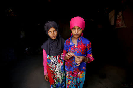 Saida Ahmed Baghili (R), 19, who is recovering from severe malnutrition, stands with her 12-year-old sister, Jalila, inside their family's hut in al-Tuhaita district of the Red Sea province of Hodeidah, Yemen, October 20, 2017. REUTERS/Abduljabbar Zeyad