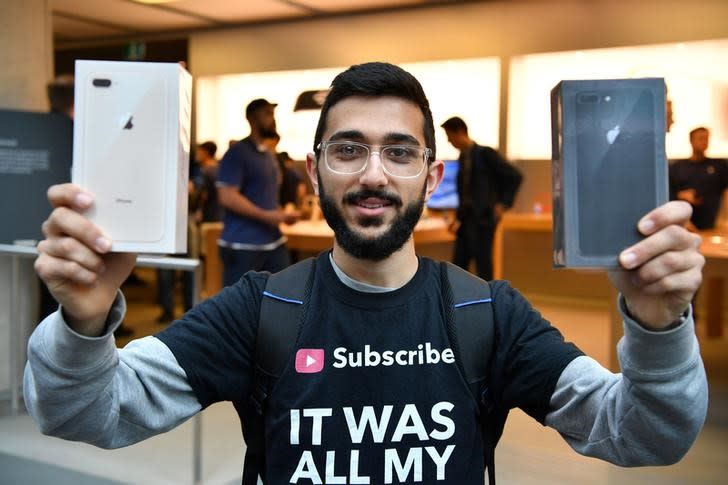 <p>Apple customer Mazen Kourouche shows off the new Apple products on the first day the iPhone 8 went on sale at the Apple Store in Sydney, Australia, September 22, 2017. AAP/Joel Carrett/via REUTERS </p>