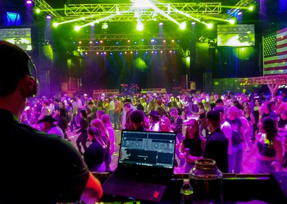 DJ Calweezy hypes up a crowd of line dancers inside the Oklahoma Ranch on Feb. 17. A popular country bar, Oklahoma Ranch, formerly known as the Cowboy Ranch, reopened Feb. 3