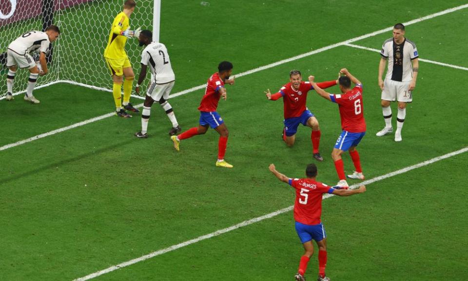 Costa Rica players celebrate their second goal against Germany.