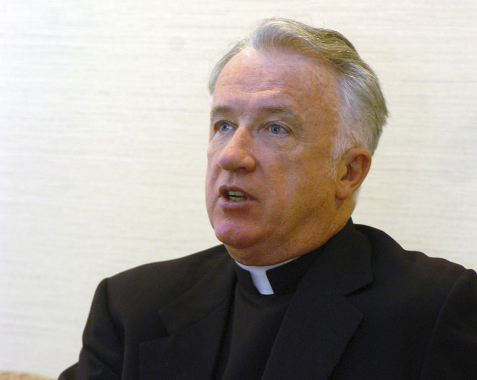 FILE - This Feb. 21, 2005 file photo, shows incoming bishop of the Wheeling-Charleston diocese, W.Va, Michael Bransfield in his new office, in Wheeling, W.Va. West Virginia's Roman Catholic diocese has released the names of nine more priests who it said have been credibly accused of child sexual abuse. West Virginia Attorney General Patrick Morrisey in March 2019 filed a lawsuit accusing the diocese and former Bishop Michael Bransfield of knowingly employing pedophiles and failing to conduct adequate background checks on camp and school workers.(AP Photo/Dale Sparks, File)