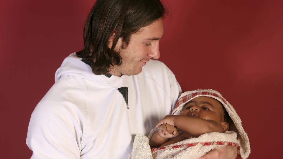 Lionel Messi holds a baby Lamine Yamal for the photoshoot in 2007. - Joan Monfort/AP