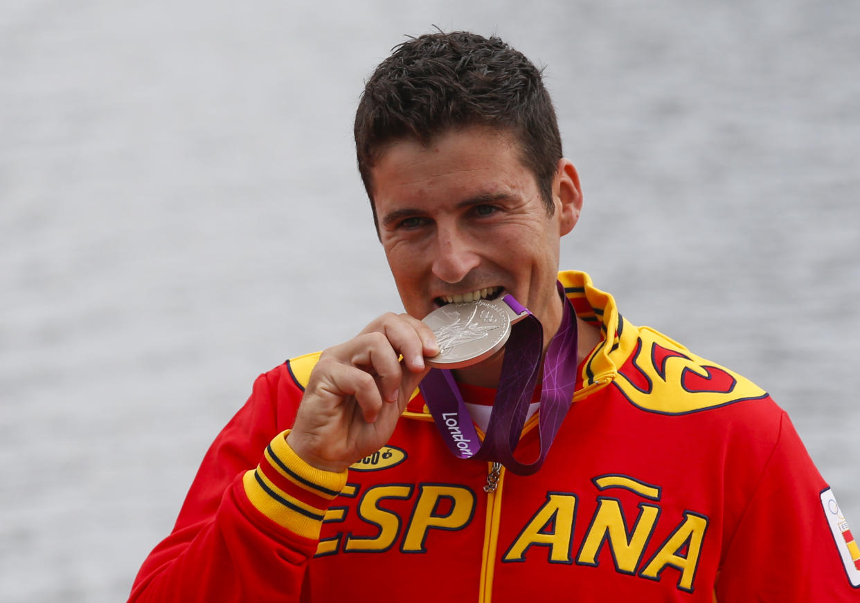 David Cal Figueroa of Spain celebrates his silver medal after the men's canoe single (C1) 1000m final at Eton Dorney at the London 2012 Olympics Games near London, August 8, 2012.             REUTERS/Jim Young (BRITAIN  - Tags: OLYMPICS SPORT CANOEING)  