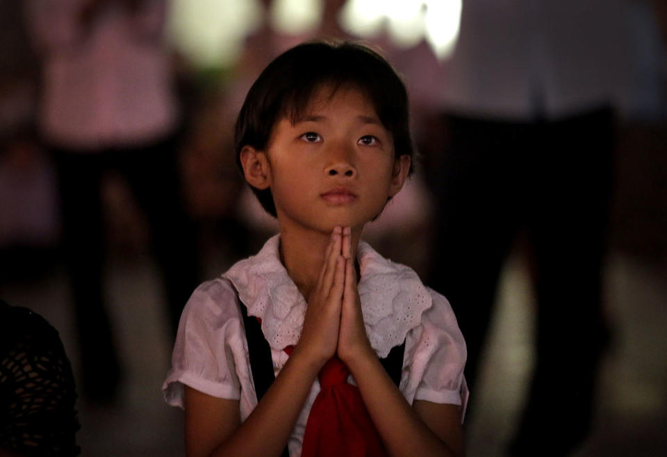 <p>A North Korean girl watches as fireworks explode, July 27, 2014, in central Pyongyang, North Korea. North Koreans gathered at Kim Il Sung Square to watch a fireworks display as part of celebrations for the 61st anniversary of the armistice that ended the Korean War. (Photo: Wong Maye-E/AP) </p>