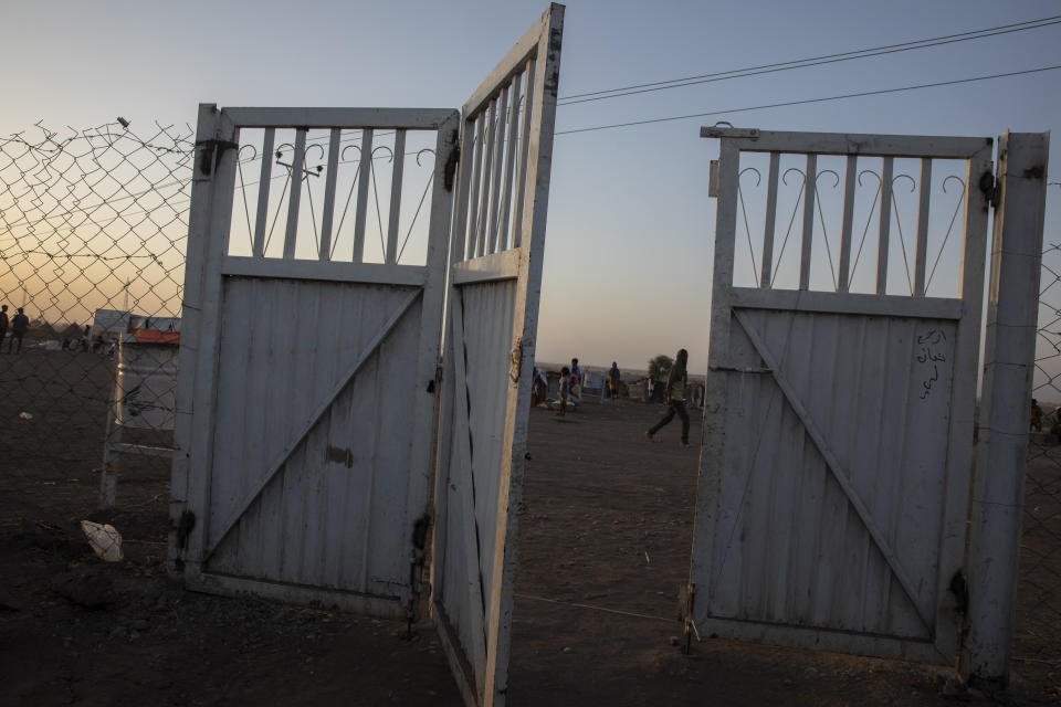 A gate stands open at the Sudanese Red Crescent clinic where surgeon and doctor-turned-refugee, Dr. Tewodros Tefera takes shelter and works in Hamdayet, eastern Sudan, near the border with Ethiopia, on March 22, 2021. (AP Photo/Nariman El-Mofty)