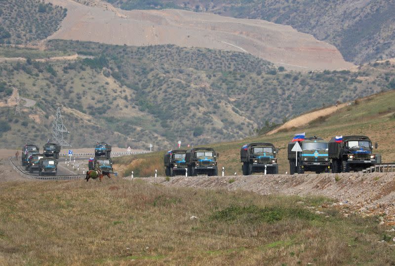 FILE PHOTO: Vehicles of Russian peacekeepers leaving Nagorno-Karabakh region pass an Armenian checkpoint near Kornidzor
