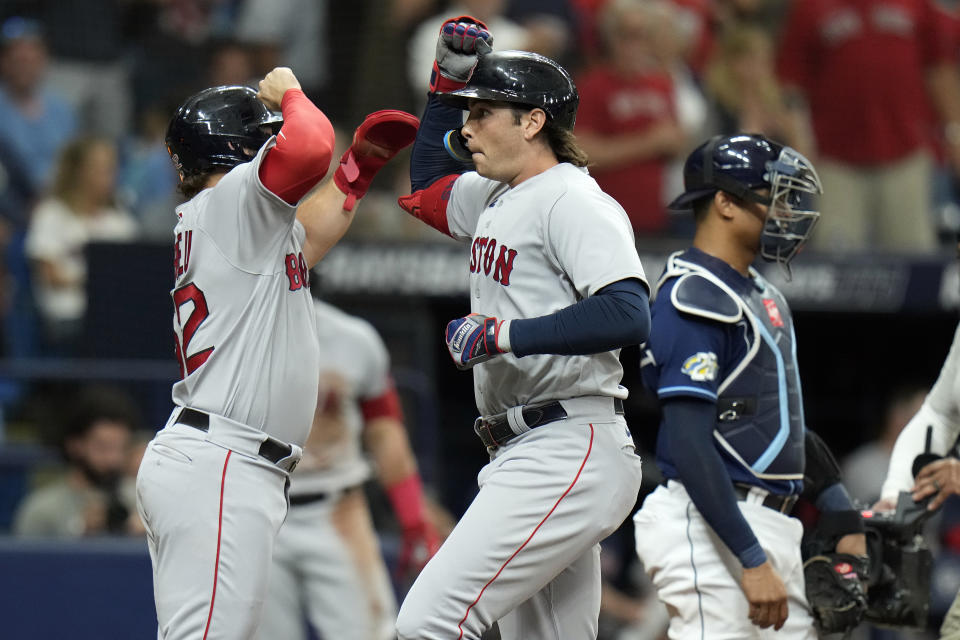 Boston Red Sox's Triston Casas, center, celebrates his three-run home run off Tampa Bay Rays relief pitcher Chris Devenski with Wilyer Abreu, left, during the sixth inning of a baseball game Monday, Sept. 4, 2023, in St. Petersburg, Fla. Catching for the Rays is Christian Bethancourt, right. (AP Photo/Chris O'Meara)