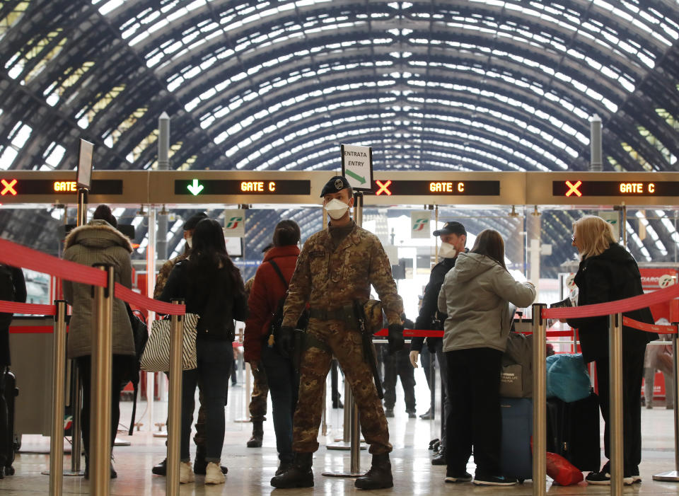 Police officers and soldiers check passengers leaving from Milan main train station, Italy, Monday, March 9, 2020. Italy took a page from China's playbook Sunday, attempting to lock down 16 million people — more than a quarter of its population — for nearly a month to halt the relentless march of the new coronavirus across Europe. Italian Premier Giuseppe Conte signed a quarantine decree early Sunday for the country's prosperous north. Areas under lockdown include Milan, Italy's financial hub and the main city in Lombardy, and Venice, the main city in the neighboring Veneto region. (AP Photo/Antonio Calanni)