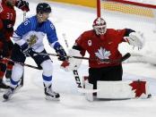 Ice Hockey - Pyeongchang 2018 Winter Olympics - Man’s Quarterfinal Match - Canada v Finland - Gangneung Hockey Centre, Gangneung, South Korea - February 21, 2018 - Goalie Kevin Poulin of Canada in action with Veli-Matti Savinainen of Finland. REUTERS/Brian Snyder