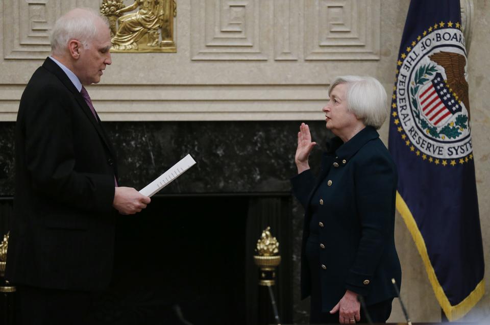 Federal Reserve Board Governor Tarullo administers the oath of office to new Federal Reserve Board Chairwoman Yellen at the Federal Reserve Board in Washington