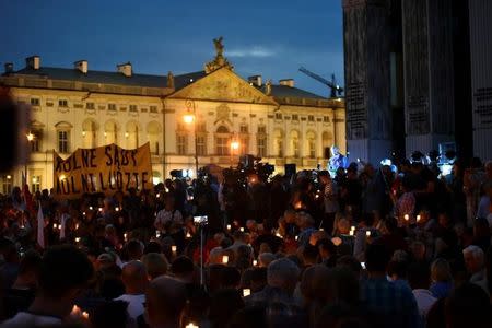 Protesters gather during a candlelight rally to protest against judicial reforms in front of the Supreme Court in Warsaw, Poland, July 16, 2017. The banner reads: "Free Courts, Free People". Agencja Gazeta/Franciszek Mazur via REUTERS