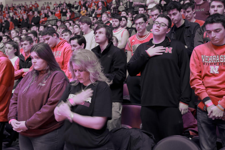 Fans observe a moment of silence to honor deceased basketball great Kobe Bryant before an NCAA college basketball game between Nebraska and Michigan, in Lincoln, Neb., Tuesday, Jan. 28, 2020. (AP Photo/Nati Harnik)