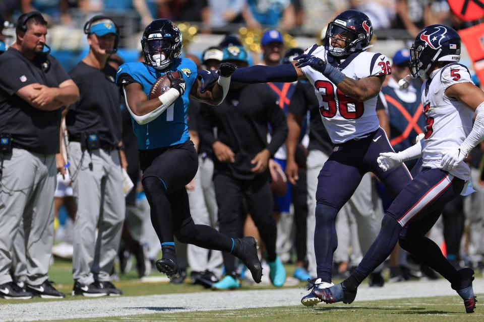 Jacksonville Jaguars running back Travis Etienne Jr. (1) is forced out of bounds by Houston Texans safety Jonathan Owens (36) during the first quarter of an NFL football game Sunday, Oct. 9, 2022 at TIAA Bank Field in Jacksonville. The Texans won 13-6. [Corey Perrine/Florida Times-Union]
