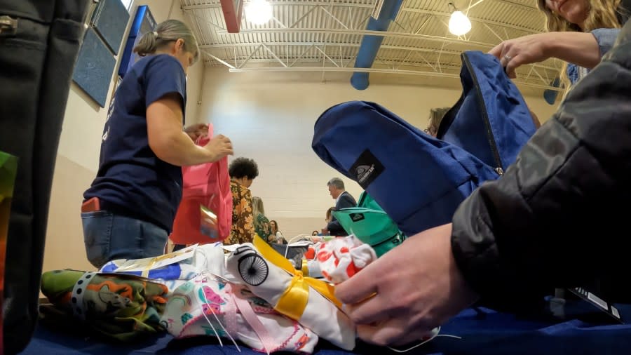 A group of volunteers filled backpacks with goodies and personal care items to support youth in foster care.