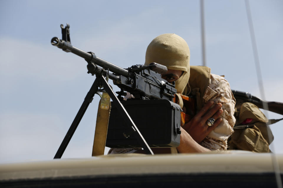 A soldier loyal to Abdul Hamid Dbeibah, one of Libya’s two rival prime ministers, patrols a street of the capital, Tripoli, Tuesday May, 17, 2022. Clashes broke out in Tripoli after Dbeibah’s rival, Prime Minister Fathi Bashagha, announced his arrival in the city on Tuesday morning. But Bashagha left soon after the fighting started. (AP Photo/Yousef Murad)