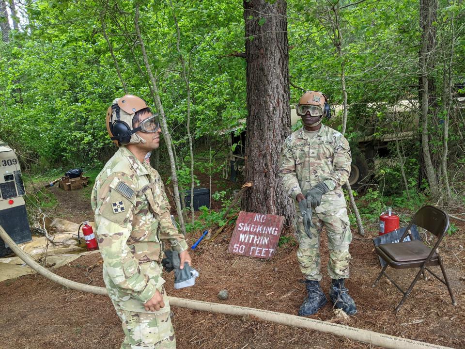 Team leader Rene Herrera, left leads Private First Class Christian Lankoande, right, during a refueling training at Fort Campbell. Lankoande recently became a citizen after immigrating from West Africa in 2015.
