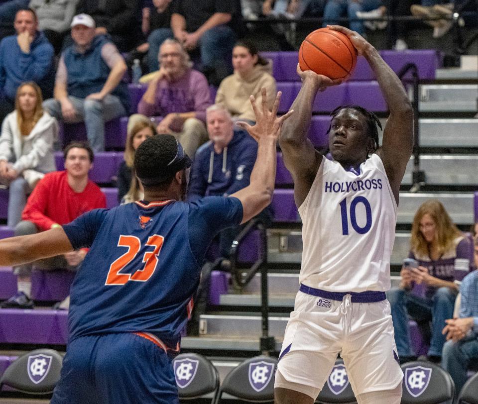 Holy Cross forward Gerald Gates shoots over Bucknell’s Andre Screen Friday afternoon at the Hart Center.