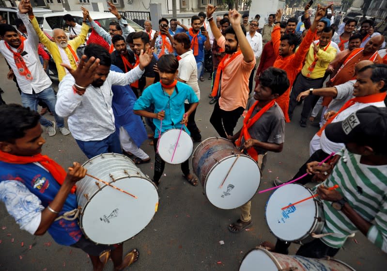 Supporters of the VHP dance during celebrations after Supreme Court's verdict on a disputed religious site in Ayodhya, in Ahmedabad