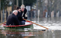 <p>Residents on a small boat leave home in a flooded street of Villeneuve-Saint-Georges, near Paris, France, Jan. 26, 2018. (Photo: Christian Hartmann/Reuters) </p>