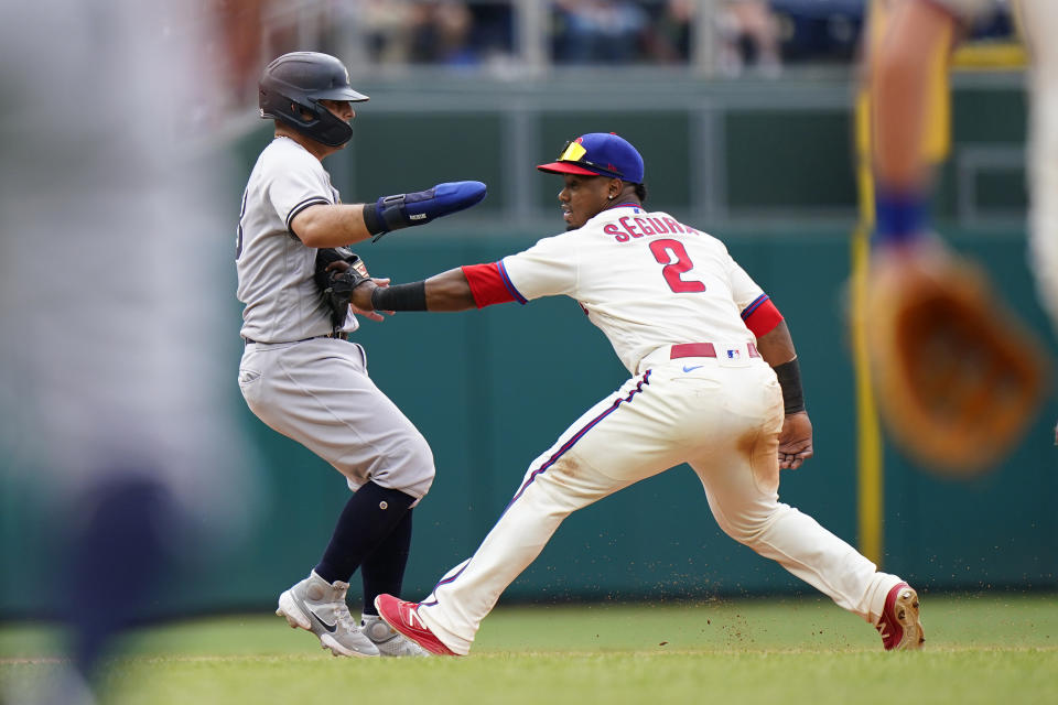 New York Yankees' Rougned Odor, left, is tagged out by Philadelphia Phillies second baseman Jean Segura after getting caught in a rundown on a fielder's choice by Gio Urshela during the seventh inning of a baseball game, Sunday, June 13, 2021, in Philadelphia. (AP Photo/Matt Slocum)