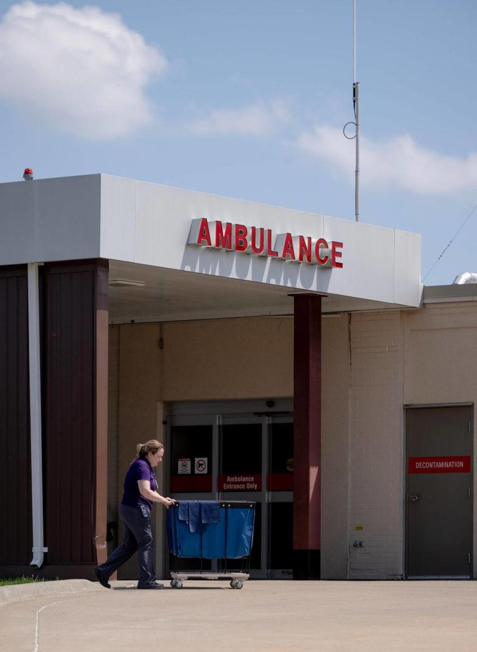 An employee of the Carroll County Memorial Hospital pushes a cart near the ambulance bay in Carrollton, Mo.