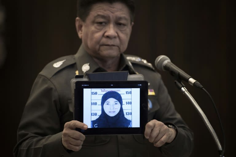 Thailand's police spokesman Prawut Thavornsiri holds a tablet displaying a picture of Wanna Suansan, 26, wanted for questioning after bomb making materials were found in a Bangkok apartment she allegedly rented