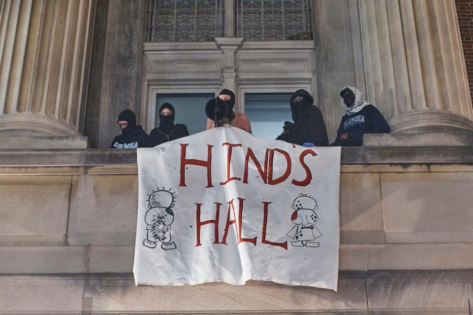 Student protestors hang a banner saying "HIND'S HALL" — a tribute to 6-year-old Hind Rajab, who was killed during Israel's military offensive in Gaza – from Hamilton Hall on Columbia University campus. <span class="copyright">Andres Kudacki for TIME</span>