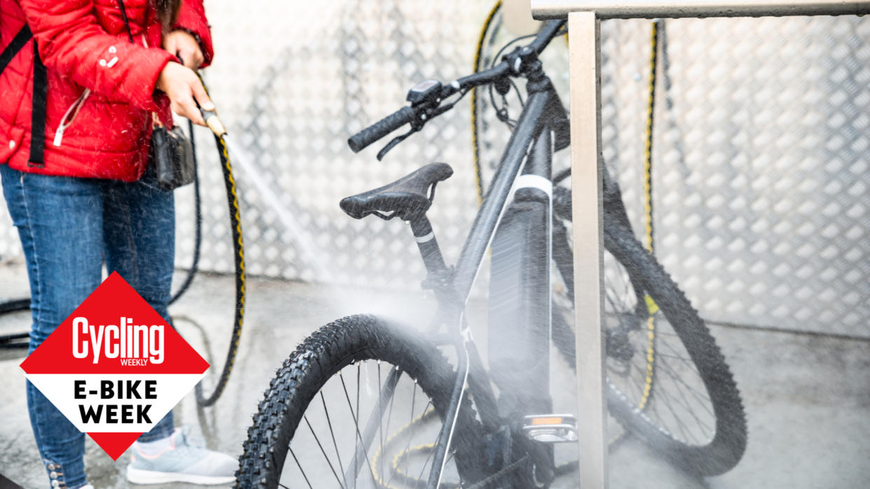  Female cyclist cleaning an electric bike 