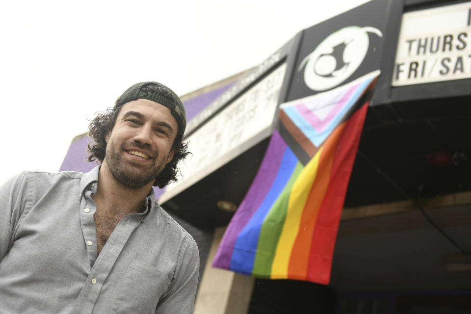 Planet Ant Theatre executive director Darren Shelton came to work on his day off so that he could hang this LGBTQ+ flag on the front of the theatre in Hamtramck, Mich., Tuesday, June 13, 2023. (Robin Buckson/Detroit News via AP)