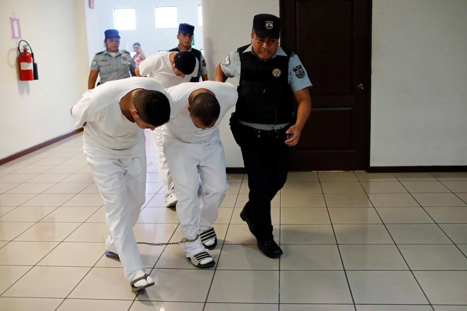 Image: Three former police officers are taken to a hearing as they face charges for aggravated homicide and the kidnapping of Camila Diaz Cordova, a transgender woman under their custody (Jose Cabezas / Reuters file)