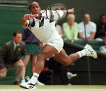 FILE - MaliVai Washington, of the United States, races across the court to play a return to Richard Krajicek, of the Netherlands, during the men's singles tennis final on Wimbledon's Centre Court on July 7, 1996. Frances Tiafoe is the first man from the United States to reach the semifinals at the U.S. Open in 16 years. And he could become the first Black man from the U.S. in a major final since MaliVai Washington was the runner-up at Wimbledon in more than a quarter-century ago. (AP Photo/James Stone, File)