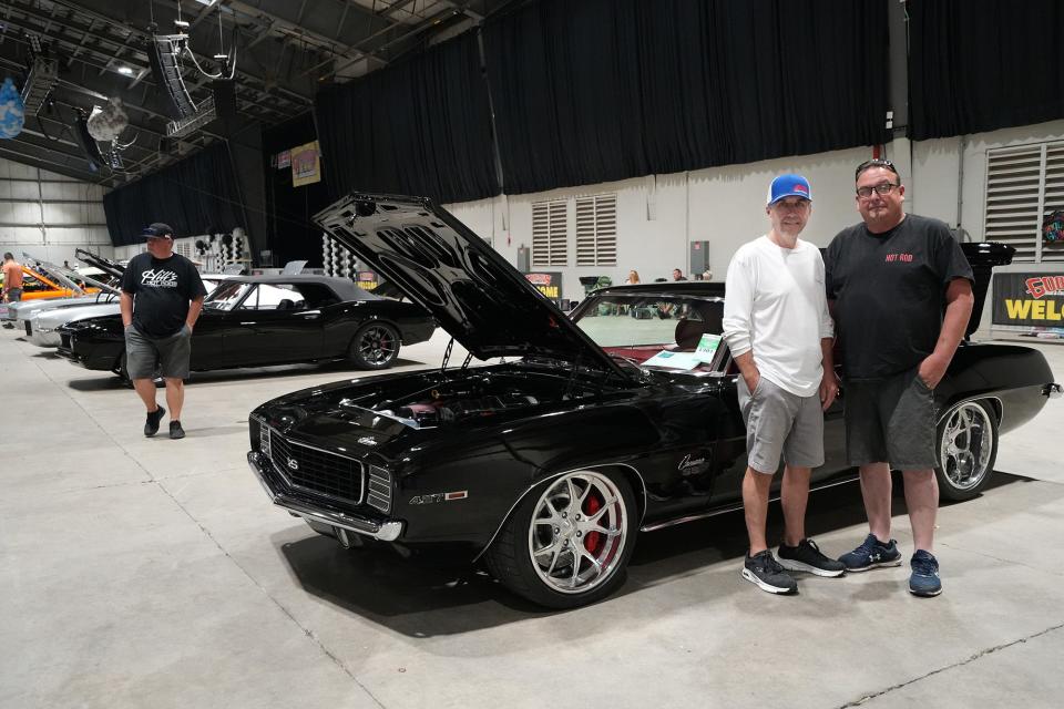 Brothers Phillip, left, and Jeff Schaeffer, stand next to their 1969 Camaro at The Goodguys 24th Summit Racing Nationals at the Ohio Expo Center on Friday.