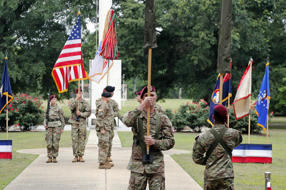 The case containing the colors of Fort Bragg, left, passes by the case containing the colors of Fort Liberty, right, during the Casing of the Colors ceremony to rename Fort Bragg on Friday, June 2, 2023, in Fort Liberty, N.C. The U.S. Army changed Fort Bragg to Fort Liberty as part of a broader initiative to remove Confederate names from bases. (AP Photo/Karl B DeBlaker)