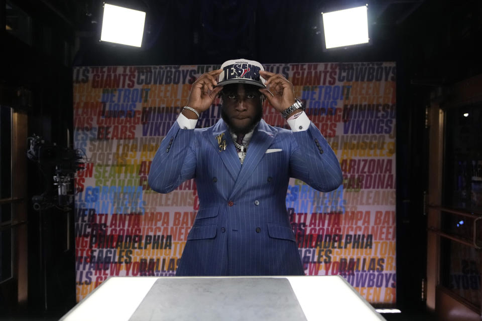 Alabama linebacker Will Anderson Jr. puts on a hat after being chosen by the Houston Texans with the third overall pick during the first round of the NFL football draft, Thursday, April 27, 2023, in Kansas City, Mo. (AP Photo/John Locher)