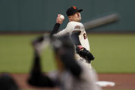 San Francisco Giants' Drew Smyly, rear, pitches against Colorado Rockies' Raimel Tapia during the first inning of a baseball game in San Francisco, Tuesday, Sept. 22, 2020. (AP Photo/Jeff Chiu)