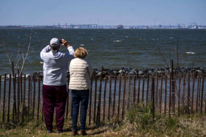 In Fort Smallwood Park in Baltimore, Md., on Friday, people gather to take photos of the collapsed Francis Scott Key Bridge and the Dali cargo vessel that rammed the bridge. Photo by Bonnie Cash/UPI