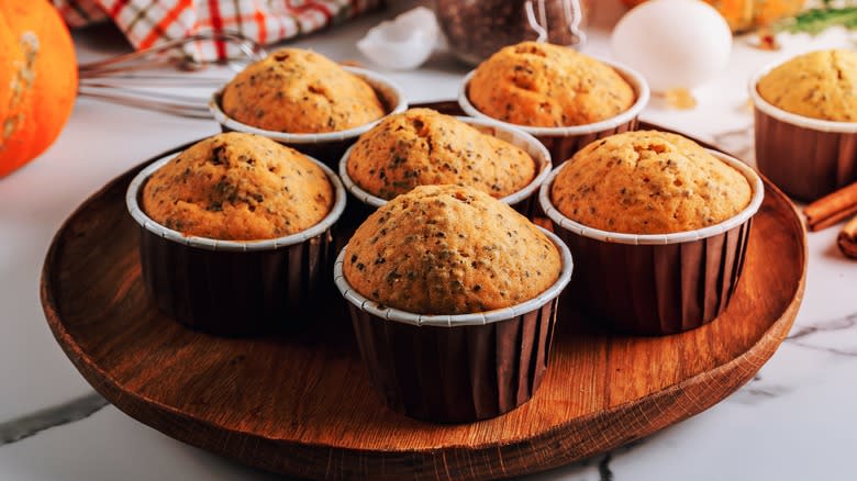 Pumpkin muffins on wooden tray 