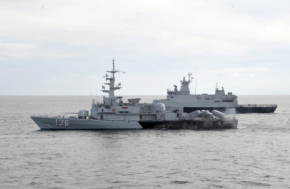 In this photo released by The Royal Malaysian Navy, Royal Malaysian Navy's missile corvette KD Laksamana Muhammad Amin, front, and Royal Malaysian Navy's offshore patrol vessel KD Selangor are seen during a search and rescue operation for the missing Malaysia Airlines plane over the Straits of Malacca, Malaysia, Thursday, March 13, 2014. Planes sent Thursday to check the spot where Chinese satellite images showed possible debris from the missing Malaysian jetliner found nothing, Malaysia's civil aviation chief said, deflating the latest lead in the six-day hunt. The hunt for the missing Malaysia Airlines flight 370 has been punctuated by false leads since it disappeared with 239 people aboard about an hour after leaving Kuala Lumpur for Beijing early Saturday. (AP Photo/The Royal Malaysian Navy)