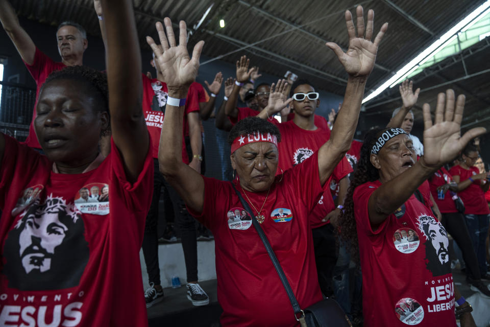 Supporters of Brazil's former President Luiz Inacio Lula da Silva, who is running for president, pray during a Workers' Party campaign rally organized by evangelical Christians, in Sao Gonçalo on the outskirts of Rio de Janeiro, Brazil, Friday, Sept. 9, 2022. Many poor evangelicals fondly remember da Silva’s 2003-2010 tenure as a time when they could afford to buy meat and pay their bills, according to Esther Solano, a sociologist at the Federal University of Sao Paulo who conducts polling of President Jair Bolsonaro voters and evangelicals. (AP Photo/Rodrigo Abd)