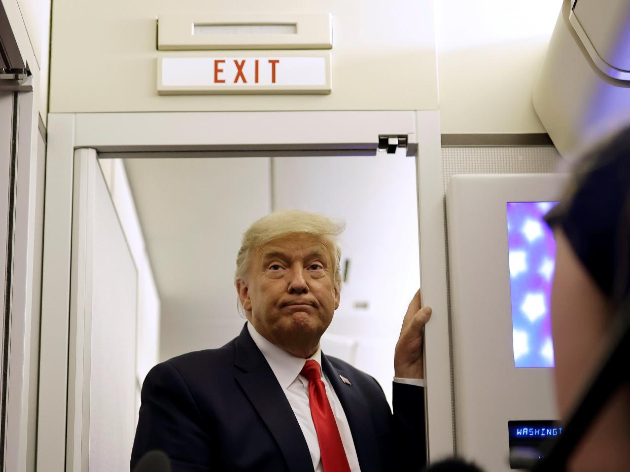  President Donald Trump pauses as he talks to journalists on board Air Force One en route to Washington D.C. after a campaign rally in Arizona on 19 October 2020 ((Reuters))