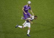 <p>Real Madrid’s Karim Benzema in action with Juventus’ Leonardo Bonucci </p>