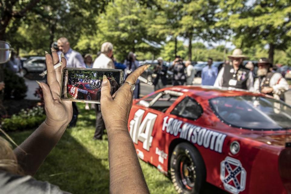 A race car sponsored by the Sons of Confederate Veterans sits outside the hotel hosting the national convention.