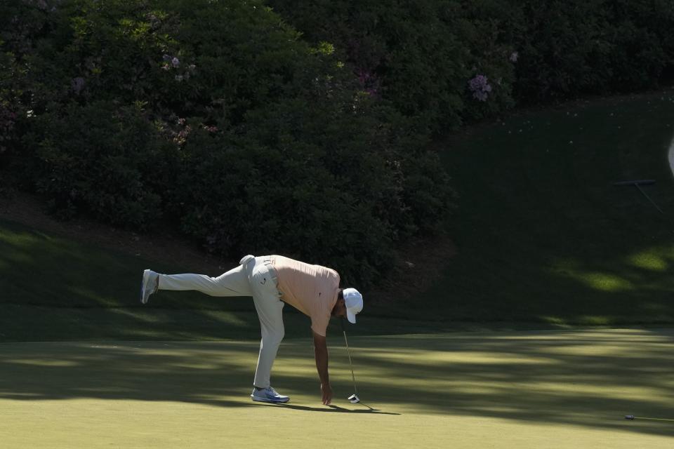 Brooks Koepka marks his ball on the 13th hole during a practice round in preparation for the Masters golf tournament at Augusta National Golf Club Sunday, April 7, 2024, in Augusta, Ga. (AP Photo/Charlie Riedel)