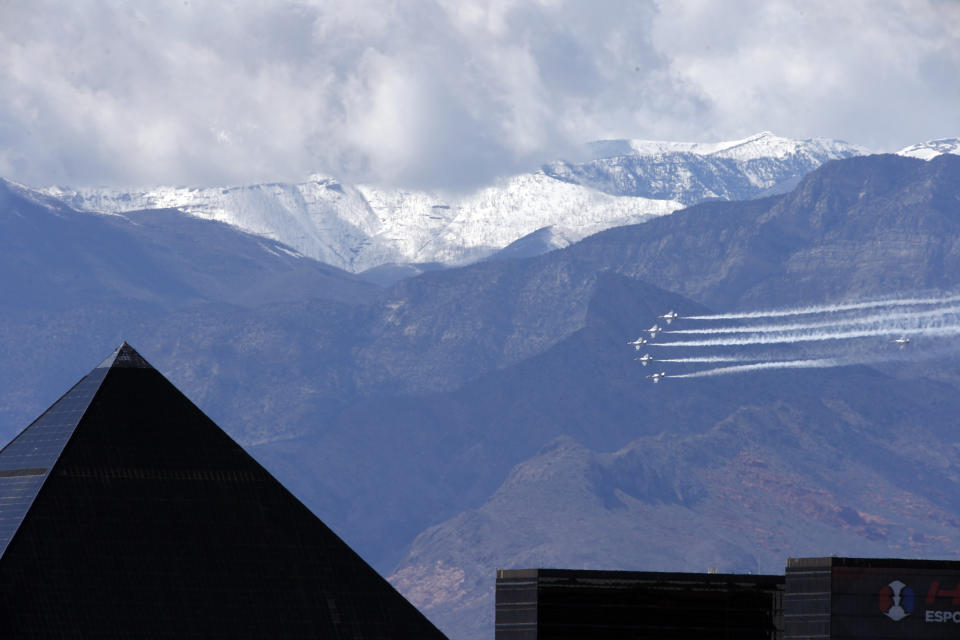 The U.S. Air Force Air flight demonstration squadron, the Thunderbirds, flies by the Luxor hotel-casino as they show their support for frontline COVID-19 healthcare workers and first responders in Las Vegas Saturday, April 11, 2020. (Steve Marcus/Las Vegas Sun via AP)