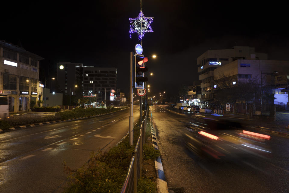 A car drives on a street during the night in Kiryat Shmona, northern Israel, Thursday, Jan. 11, 2024. Israel ordered the evacuation of civilians from the border towns with Lebanon. The prospect of a full-scale war between Israel and Lebanon’s Hezbollah militia terrifies people on both sides of the border, but some see it as an inevitable fallout from Israel’s ongoing war against Hamas in Gaza. (AP Photo/Leo Correa)