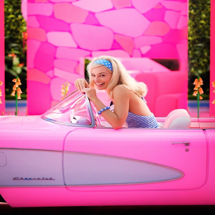 Margot Robbie as Barbie in a car