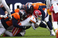 Kansas City Chiefs running back Jerick McKinnon (1) is stopped by Denver Broncos defensive end Ronnie Perkins (51) and defensive end Matt Henningsen (91) during the first half of an NFL football game Sunday, Oct. 29, 2023, in Denver. (AP Photo/Jack Dempsey)