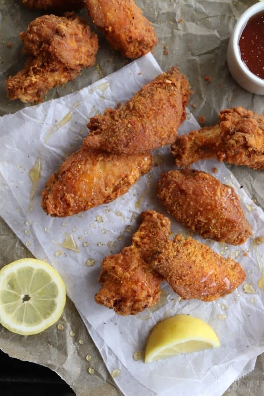 <p>Razzle Dazzle Life</p><p>Lemon Pepper Honey chicken wings where the honey is infused with a nice lemon pepper flavor and then drizzled over extra crispy, lightly breaded chicken wings to create the perfect balance of savory sweet!</p><p><strong>Get the Recipe:</strong><a href="https://www.razzledazzlelife.com/lemon-pepper-honey-chicken-wings/" rel="nofollow noopener" target="_blank" data-ylk="slk:Lemon Pepper Honey Chicken Wings;elm:context_link;itc:0;sec:content-canvas" class="link "> <strong>Lemon Pepper Honey Chicken Wings</strong></a></p>