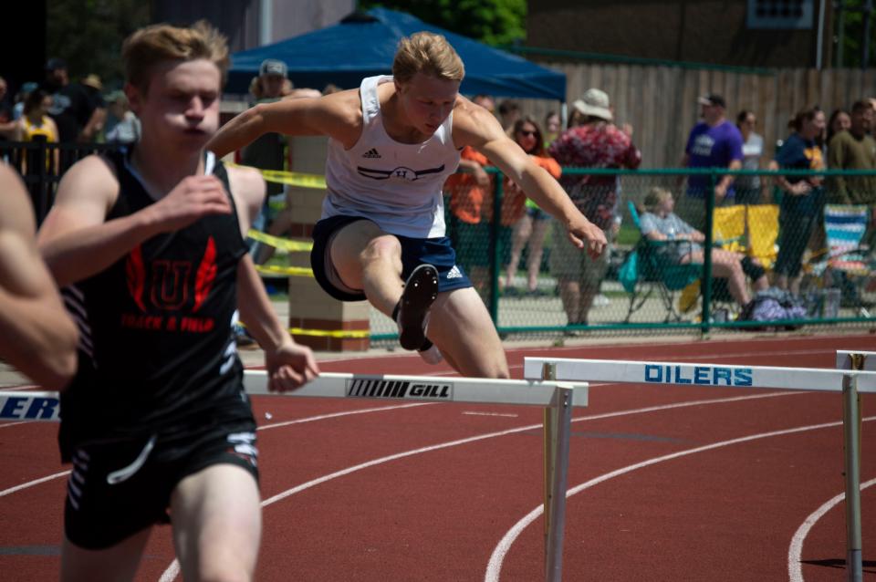 Hillsdale Academy senior David Richards clears a hurdle in the 300-meter race